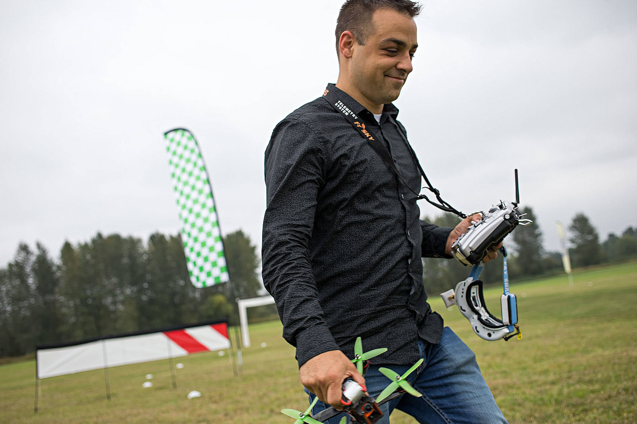Nathan Sutton smiles after a session of flying a drone through a course Sept. 8 at DieHard RC Park in Snohomish. Sutton, a former Marine, has found flying drones as a useful way of dealing with Post Traumatic Distress Syndrome, and DieHard RC has been sponsoring him. (Andy Bronson / The Herald)                                Nathan Sutton smiles after a session of flying a drone through a course Sept. 8 at DieHard RC Park in Snohomish. Sutton,a former Marine, has found flying drones as a useful way of dealing with Post Traumatic Distress Syndrome, and DieHardRC has been sponsoring him. (Andy Bronson / The Herald)