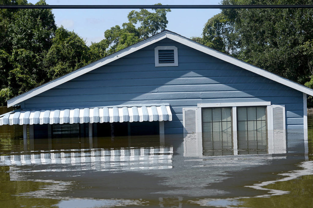 A house is flooded due to Hurricane Harvey in the north end of Beaumont, Texas, on Thursday. (Ryan Pelham/The Beaumont Enterprise via AP)
