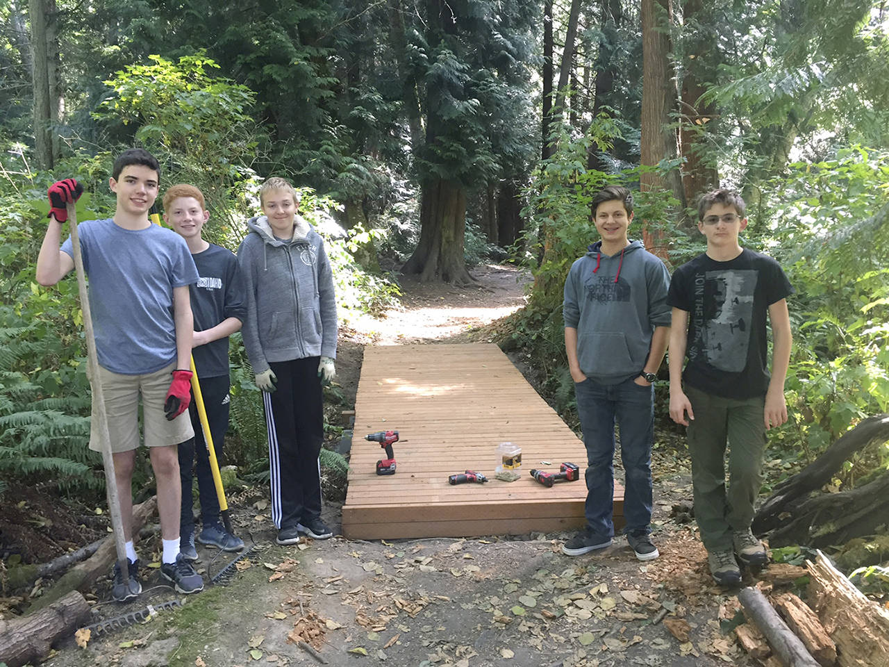 This bridge was built over a gully in Mukilteo’s Japanese Gulch Park, constructed as part of an Eagle Scout project by Ethan Papenhausen (He is second from right, wearing the North Face sweatshirt). Members of Boy Scout Troop 16 constructed the bridge Aug. 19. Less than two weeks later, wood from the new bridge was stolen, leaving only the frame. (Papenhausen family)