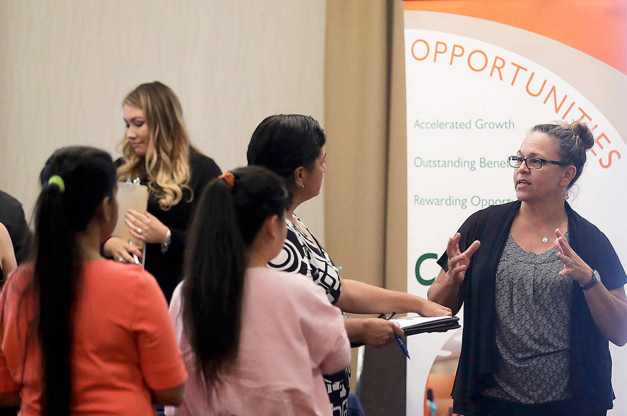 A recruiter for retailer Big 5 Sporting Goods (right), talks to job seekers during a job fair in San Jose, California., on Aug. 24. (AP Photo/Marcio Jose Sanchez)