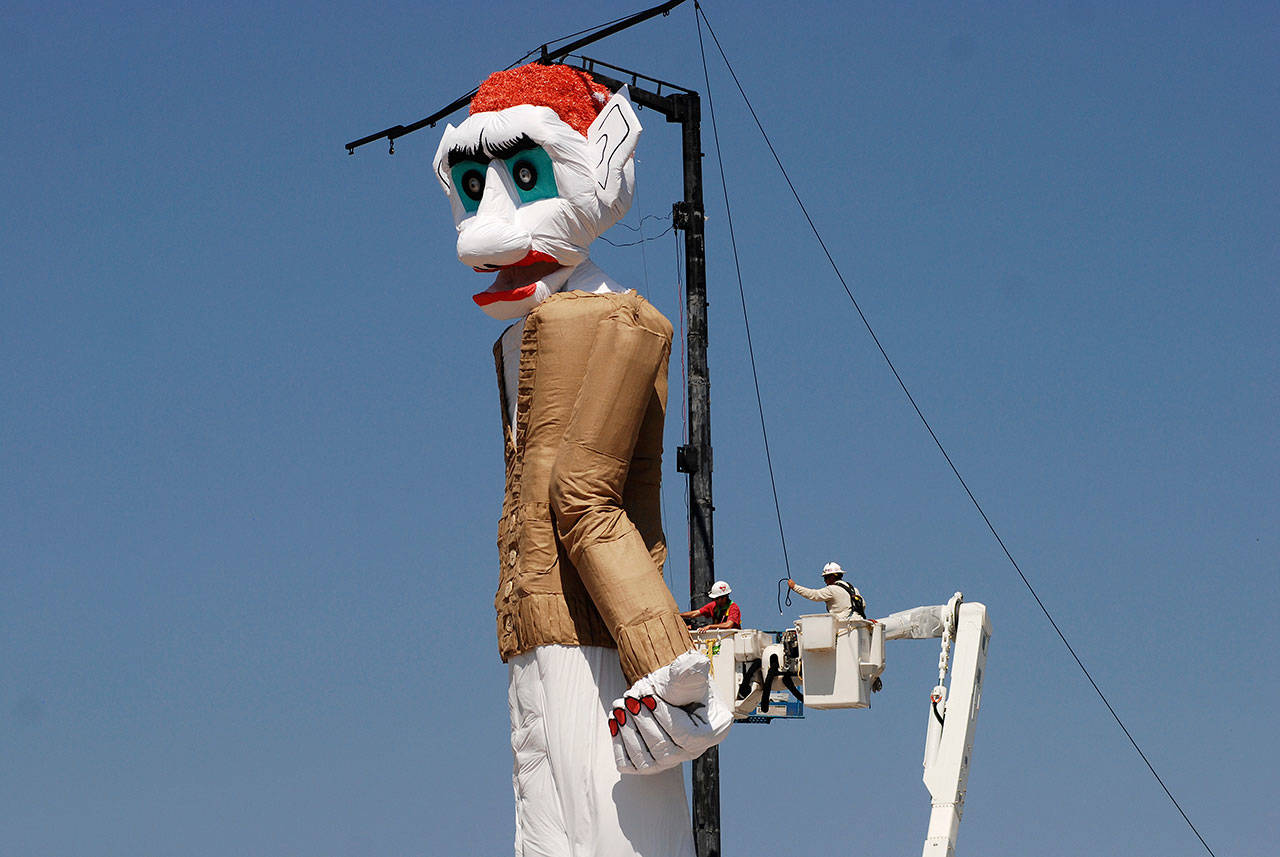 Workers prepare the towering Zozobra marionette for its annual burning at a city park in Santa Fe, New Mexico, on Friday. Inside the six-story puppet are reams of crumpled, handwritten notes about recent troubles and travails that people hope to leave behind. (Morgan Lee / Associated Press)