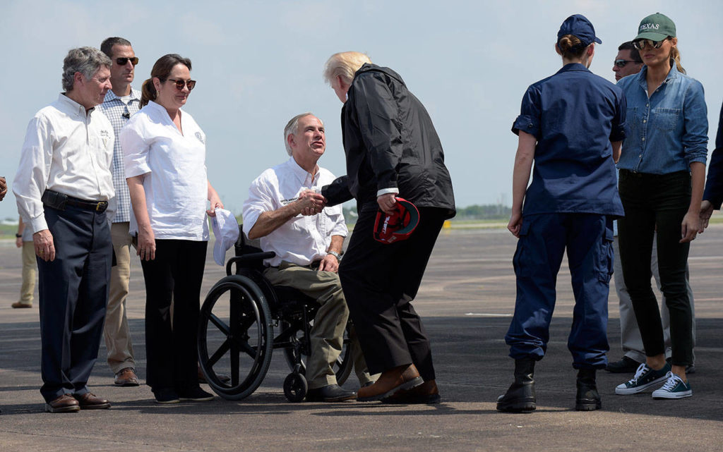 President Donald Trump shakes hands with Texas Gov. Greg Abbott as he and first lady Melania Trump, right, arrive via Air Force One at Ellington Field in Houston, Saturday, Sept. 2, 2017. The president and first lady Melania Trump arrived Saturday morning in Houston, and their first order of business is to meet with people impacted by the storm and flooding. They’re also set to stop by a relief center to speak with volunteers and then head to Lake Charles, Louisiana, another area devastated by Harvey. (AP Photo/Susan Walsh)
