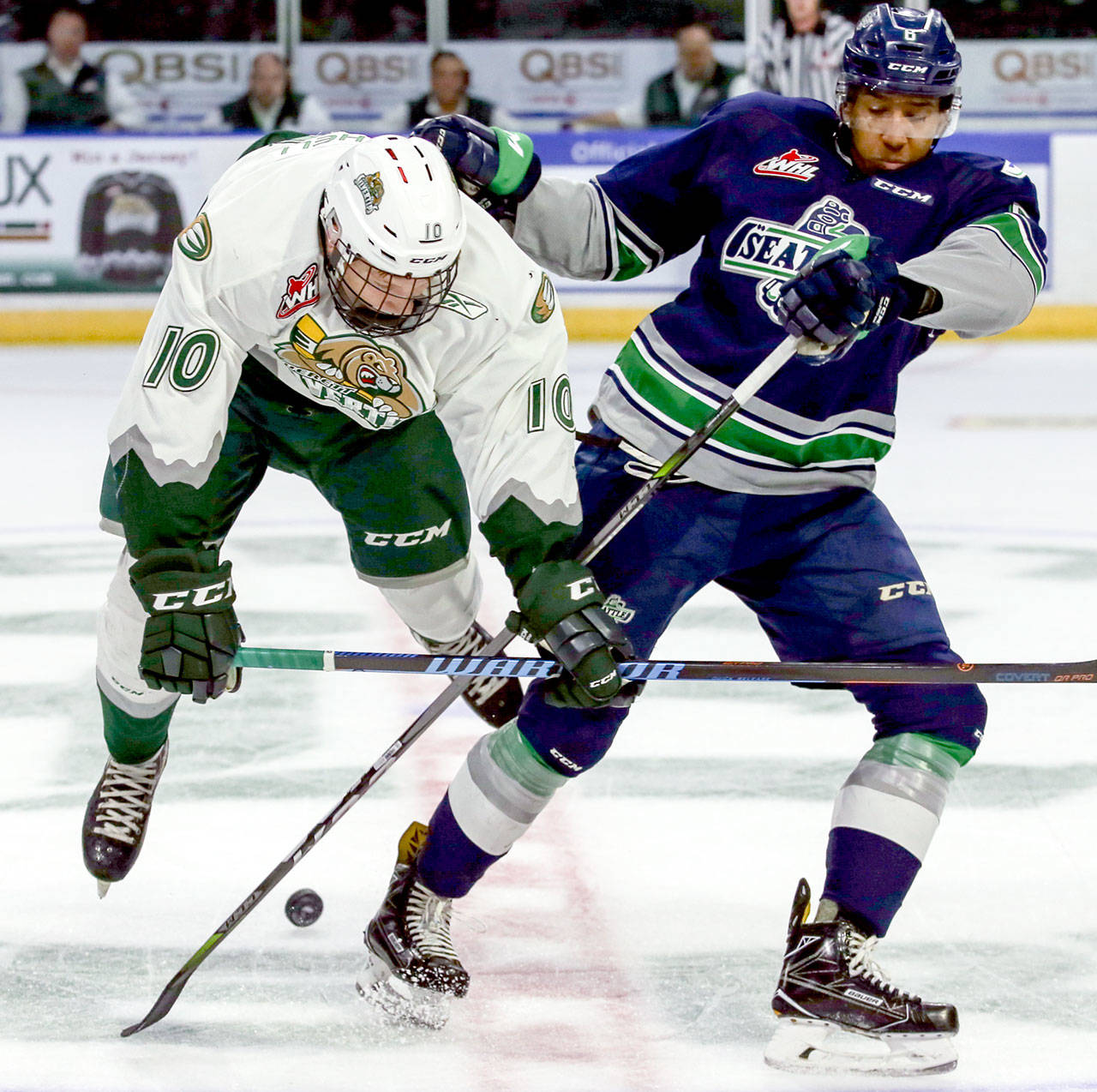 The Silvertips’ Conrad Mitchell is tripped by the Thunderbirds’ Aaron Hyman in the first period of a preseason game Sept. 2, 2017, at Xfinity Arena in Everett. (Kevin Clark / The Herald)