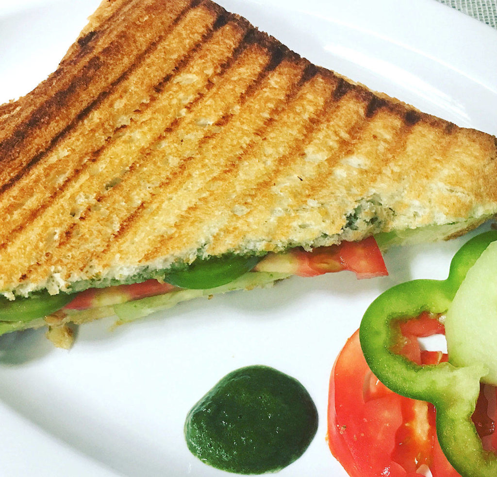 Veggie paninis with mint chutney are made with slices of cucumber, bell pepper and tomato. (Reshma Seetharam)
