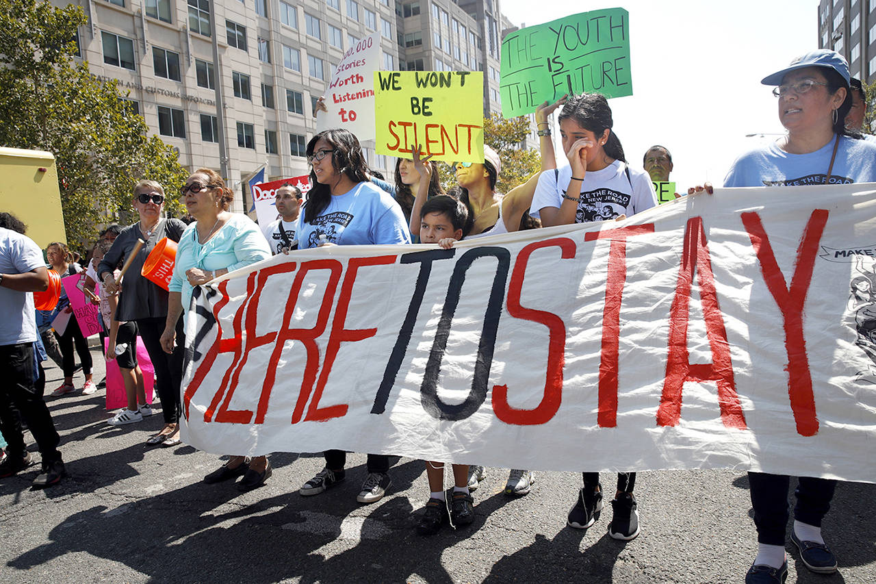 Cielo Mendez (second from left with banner), 17, of Plainfield, New Jersey, who is a DACA recipient, marches next to Gabriel Henao, 7, and Kimberly Armas, 15, of Elizabeth, New Jersey, in support of the Deferred Action for Childhood Arrivals program, known as DACA, outside of Immigration and Customs Enforcement (ICE) in Washington on Tuesday. (AP Photo/Jacquelyn Martin)