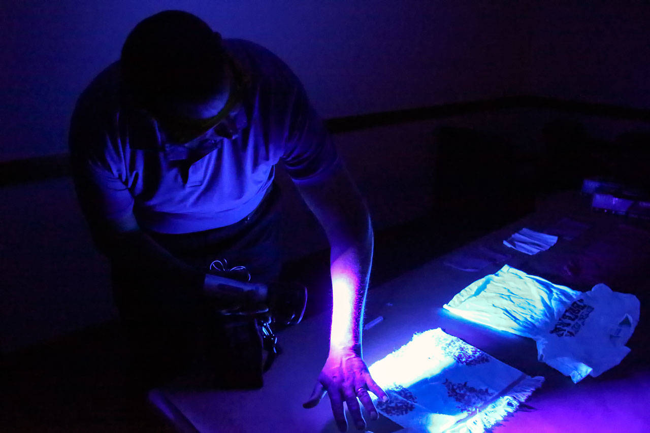 Detective Rich Emmons demonstrates the forensic light that recently was donated to Dawson Place Child Advocacy Center in Everett. (Kevin Clark / The Herald)