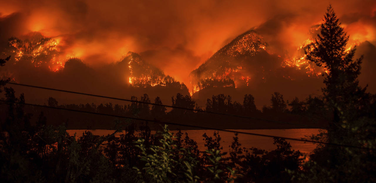 This Sept. 4 photo shows a wildfire as seen from near Stevenson Washington, across the Columbia River, burning in the Columbia River Gorge above Cascade Locks, Oregon. (Tristan Fortsch/KATU-TV via AP, file)
