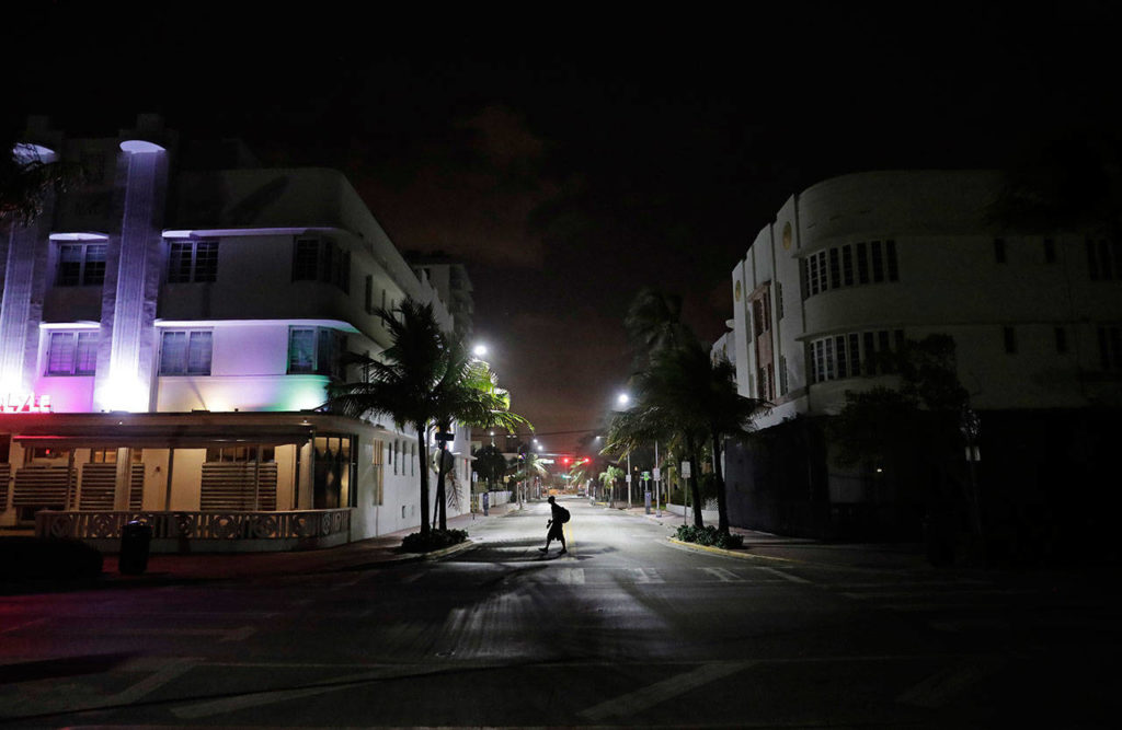 A lone pedestrian walks through the usual bustling South Beach ahead of Hurricane Irma in Miami Beach, Fla., Friday, Sept. 8, 2017. Florida has asked 5.6 million people to evacuate ahead of Hurricane Irma, or more than one quarter of the state’s population, according to state emergency officials. (AP Photo/David Goldman)
