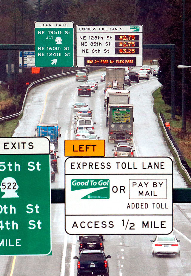 Signs show the rates for using the express toll lanes for traffic headed southbound on I-405 in February 2016. (AP File Photo)