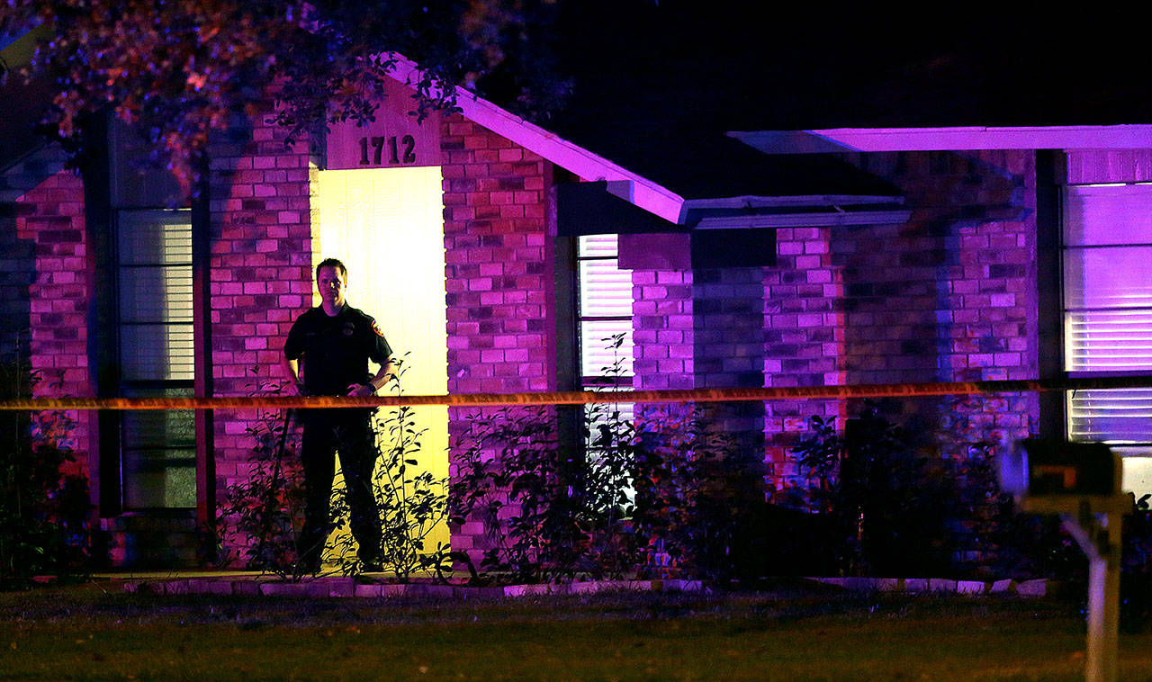 A police officer stands guard outside the scene of a mass shooting in Plano, Texas, Sunday. (AP Photo/LM Otero)