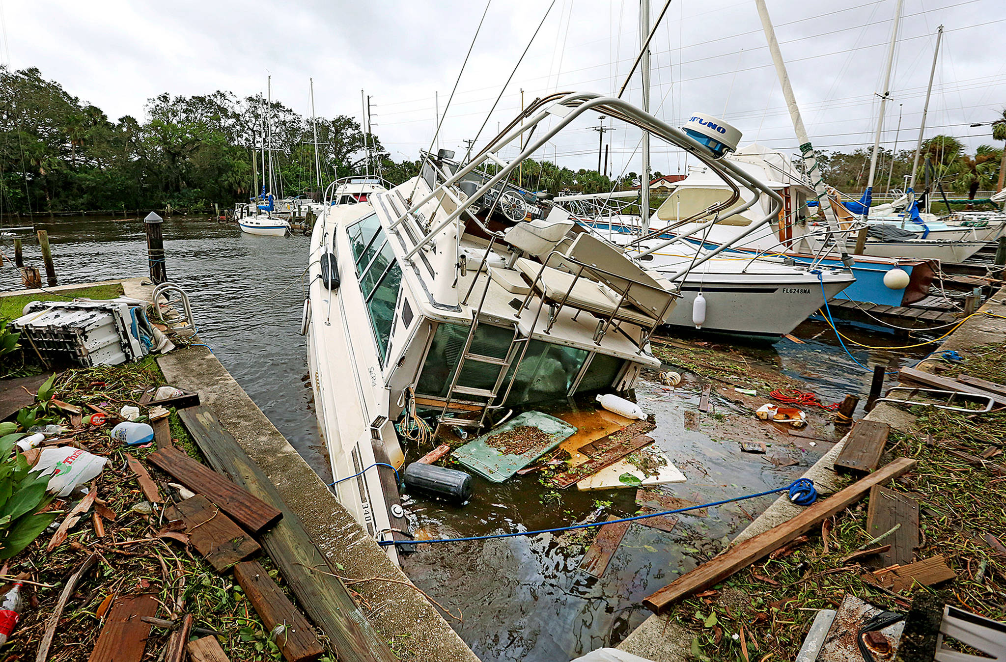 A sinking boat is surrounded by debris in the aftermath of Hurricane Irma at Sundance Marine in Palm Shores, Florida, on Monday. (Red Huber/Orlando Sentinel via AP)