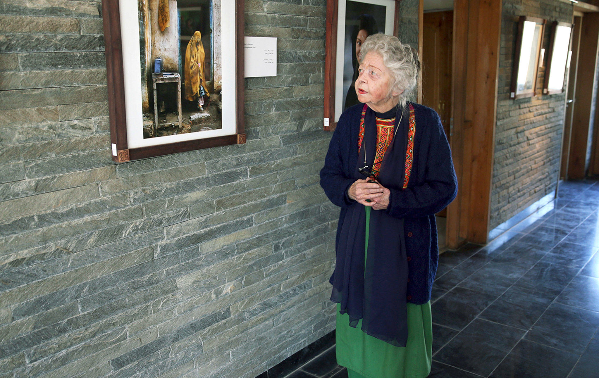 In this Dec. 2014 photo, American historian Nancy Hatch Dupree talks about a photo taken by National Geographic photographer Steve McCurry during an interview with The Associated Press at the Afghanistan Center at Kabul University. (AP Photo/Massoud Hossaini)