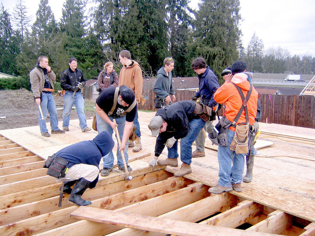 District carpentry students decking the first floor on house No. 34 in 2008.
