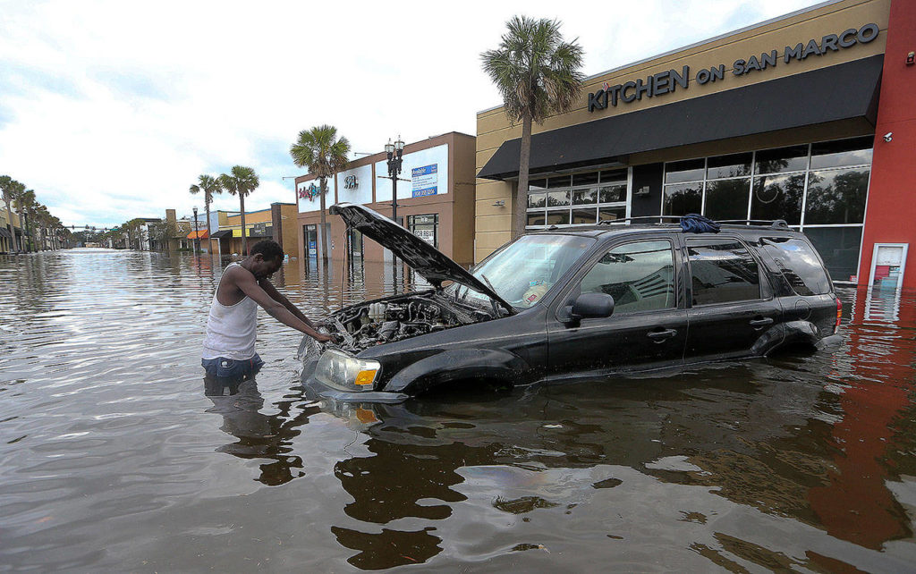 John Duke tries to figure out how to salvage his flooded vehicle in the wake Hurricane Irma on Monday in Jacksonville, Florida. (AP Photo/John Bazemore)
