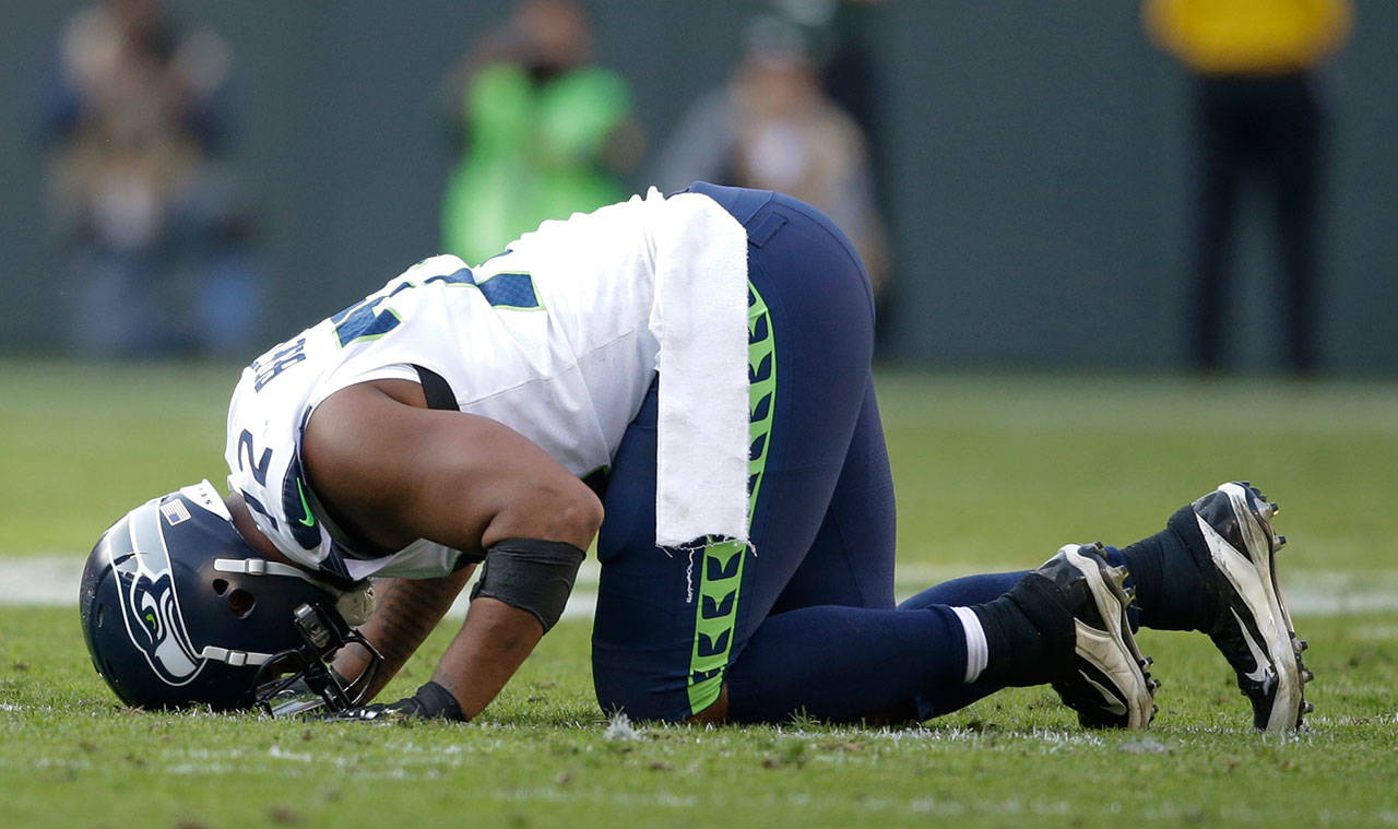 The Seahawks’ Michael Bennett reacts after hurting his leg during the second half of a game against the Packers on Sept. 10, 2017, in Green Bay, Wis. (AP Photo/Jeffrey Phelps)