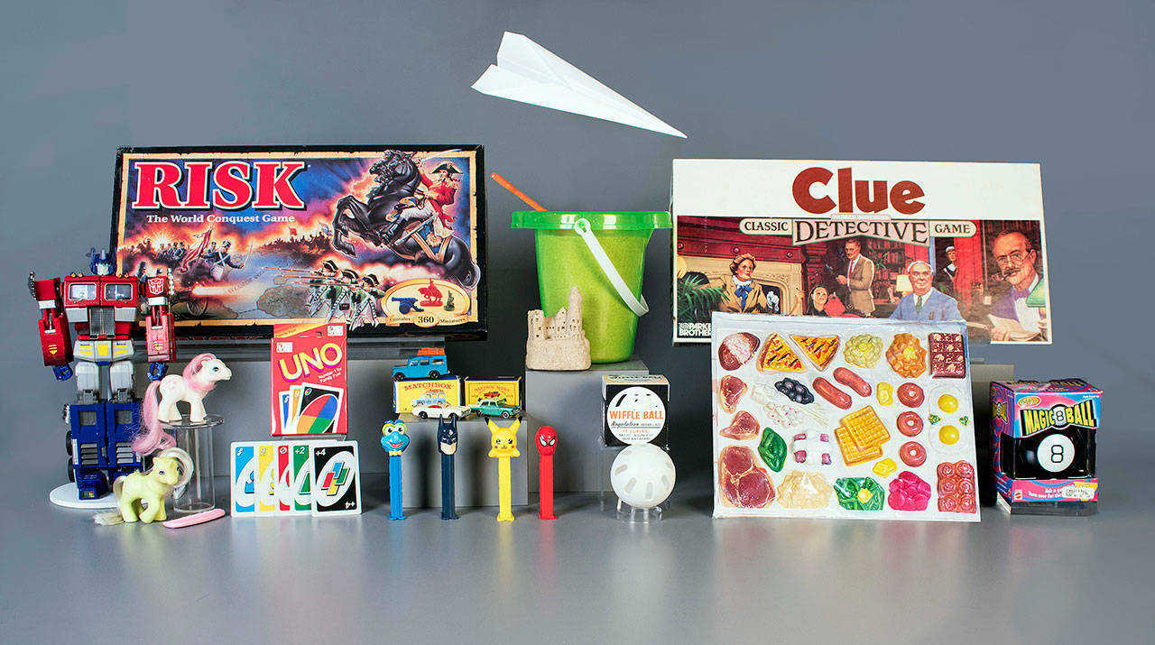 The 12 finalists for the Class of 2017 induction into the National Toy Hall of Fame. The winners, chosen from among the finalists by a national selection committee, will be inducted into the Rochester, N.Y., hall on Nov. 12, 2017. At the top center is the paper airplane. From rear left are Risk, sand and Clue. From second row left are: Transformers, My Little Pony, UNO, Matchbox Cars, Wiffle Ball, play food, and Magic 8 Ball. The PEZ candy dispenser at center foreground. (Victoria Gray / The Strong museum)