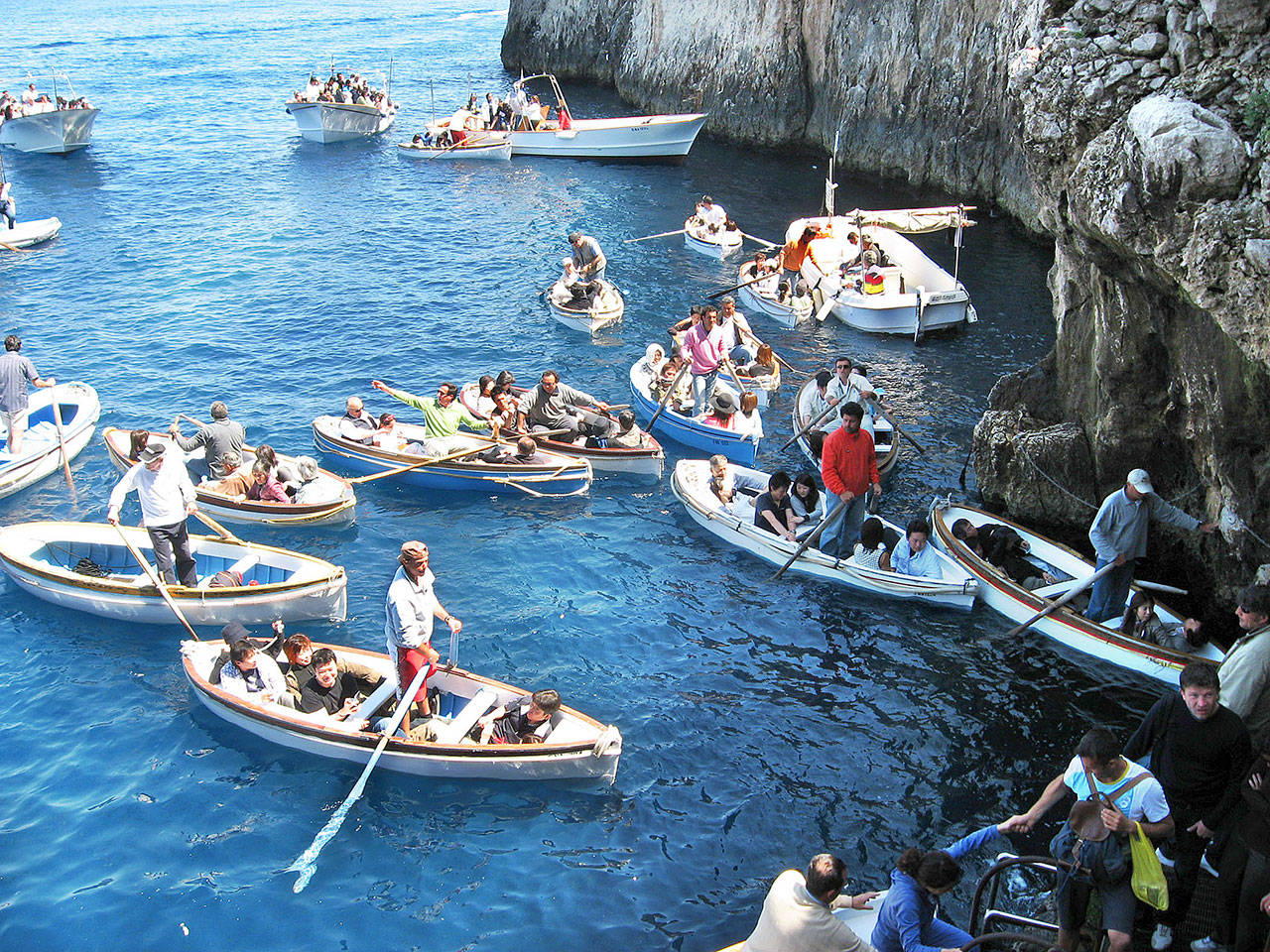 Boats jockey for position as they get ready to enter the Blue Grotto in the island of Capri in southern Italy. (Rick Steves’ Europe)