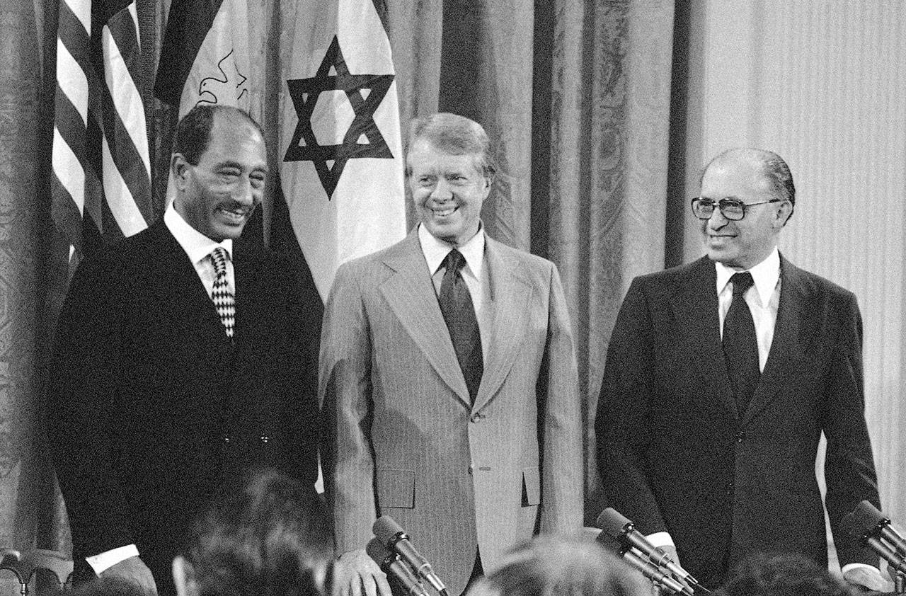 Egyptian President Anwar Sadat, President Jimmy Carter and Israeli Prime Minister Menachen Begin gather in the East Room of the White House in Washington on Sept. 17, 1978, to sign a framework for a peace treaty. The leaders had earlier hammered out the agreement during meetings at Camp David. (Associated Press archive)