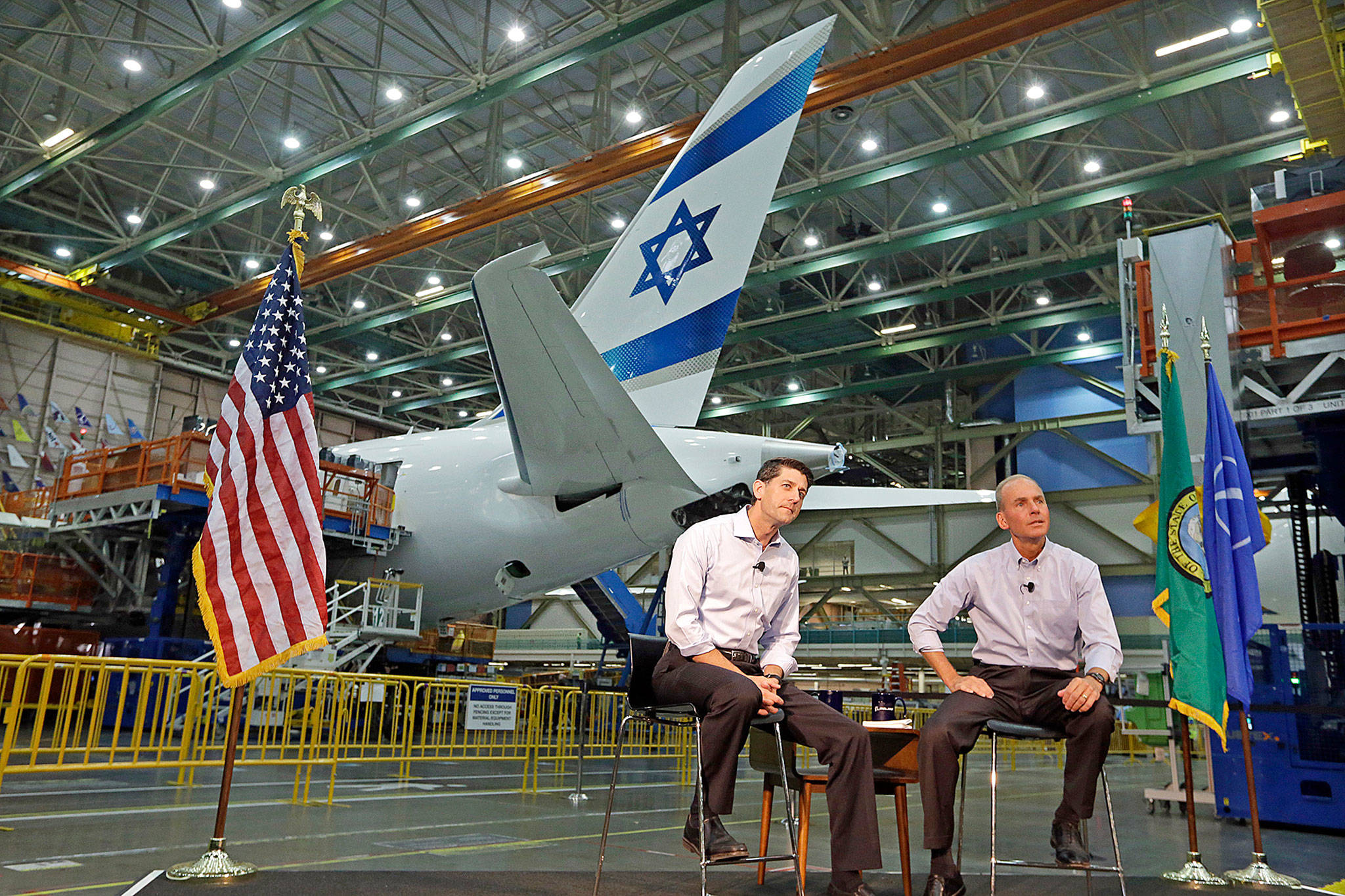 House Speaker Paul Ryan (left), and Boeing CEO Dennis Muilenburg listen to Boeing workers on the 787 production line Aug. 24 in Everett. (AP Photo/Elaine Thompson)