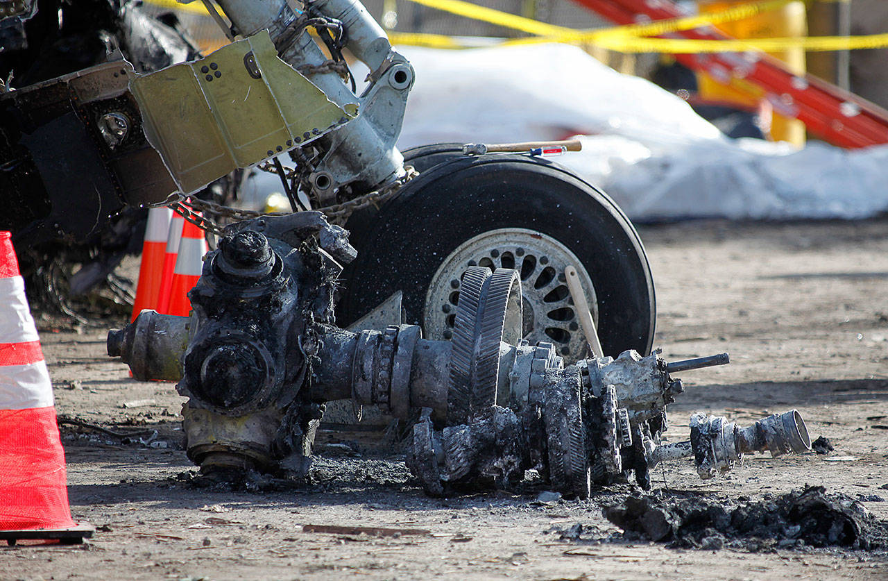 FILE - In this Feb. 16, 2009, file photo, debris at the scene of a plane crash site of Continental Connection Flight 3407 in Clarence Center, N.Y. An influential industry panel plans to vote Sept. 14, 2017, on recommendations that the Federal Aviation Administration eliminate or scale back dozens of safety rules, including one on airline pilot qualifications. The recommendations are contained in a report to the FAA’s Aviation Rulemaking Advisory Committee in response to President Donald Trump’s directives to cut government regulations. (AP Photo/David Duprey, pool)