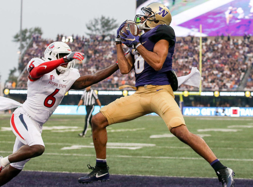 Washington’s Dante Pettis makes a touchdown reception over Fresno State’s Tank Kelly on Sept. 16, 2017, at Husky Stadium in Seattle. (Kevin Clark / The Herald)
