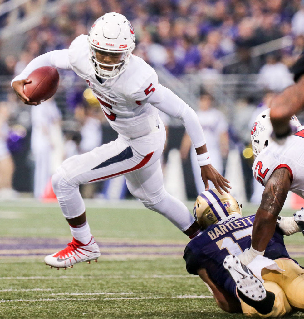 Fresno State’s Chason Virgil is sacked by Washington’s Tevis Bartlett on Sept. 16, 2017, at Husky Stadium in Seattle. (Kevin Clark / The Herald)
