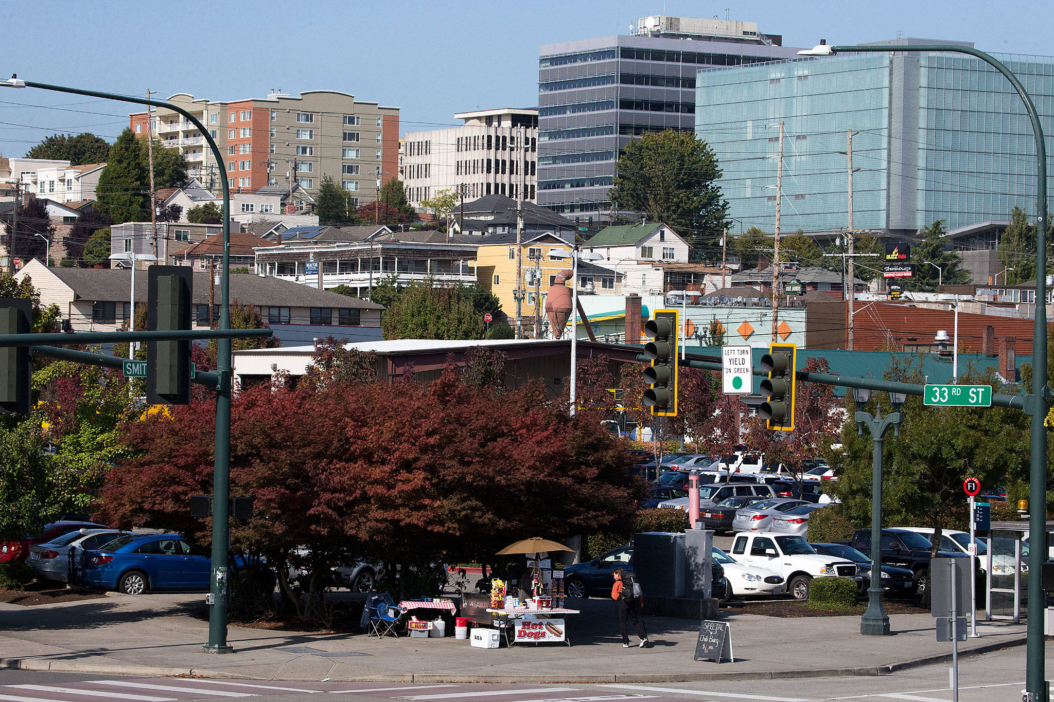 A customer walks away after buying a hot dog from a vendor on 33rd St and Smith Street near the Everett Station on Friday. The Everett Station District Alliance pictures the area east of Broadway and south of Hewitt Avenue as a future neighborhood and transit hub that could absorb expected population growth. (Andy Bronson / The Herald)