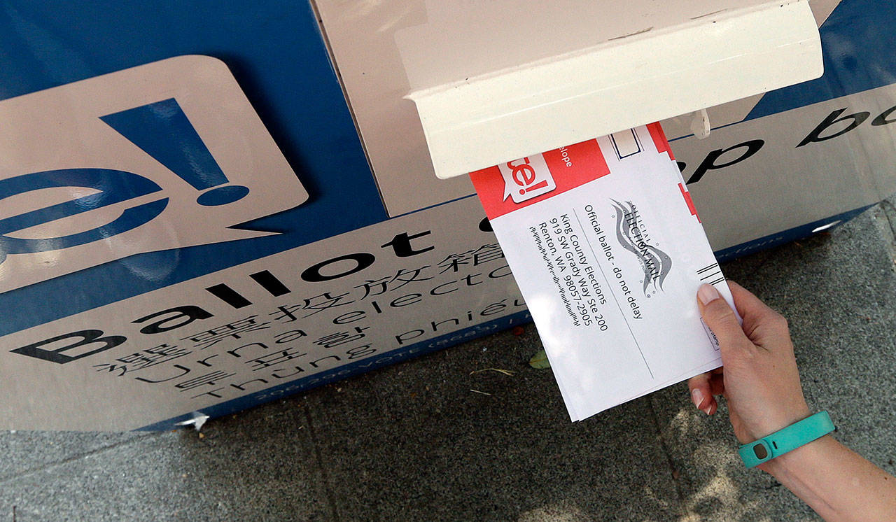 A ballot is dropped into a voting box as voters cast ballots in the Aug. 1 primary election. (Elaine Thompson/Associated Press)