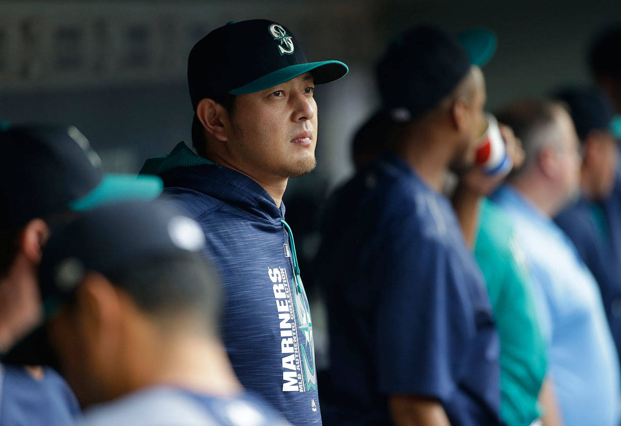 Mariners pitcher Hisashi Iwakuma (center) stands in the dugout before the team’s game against the Yankees on July 21, 2017, in Seattle. (AP Photo/Ted S. Warren)