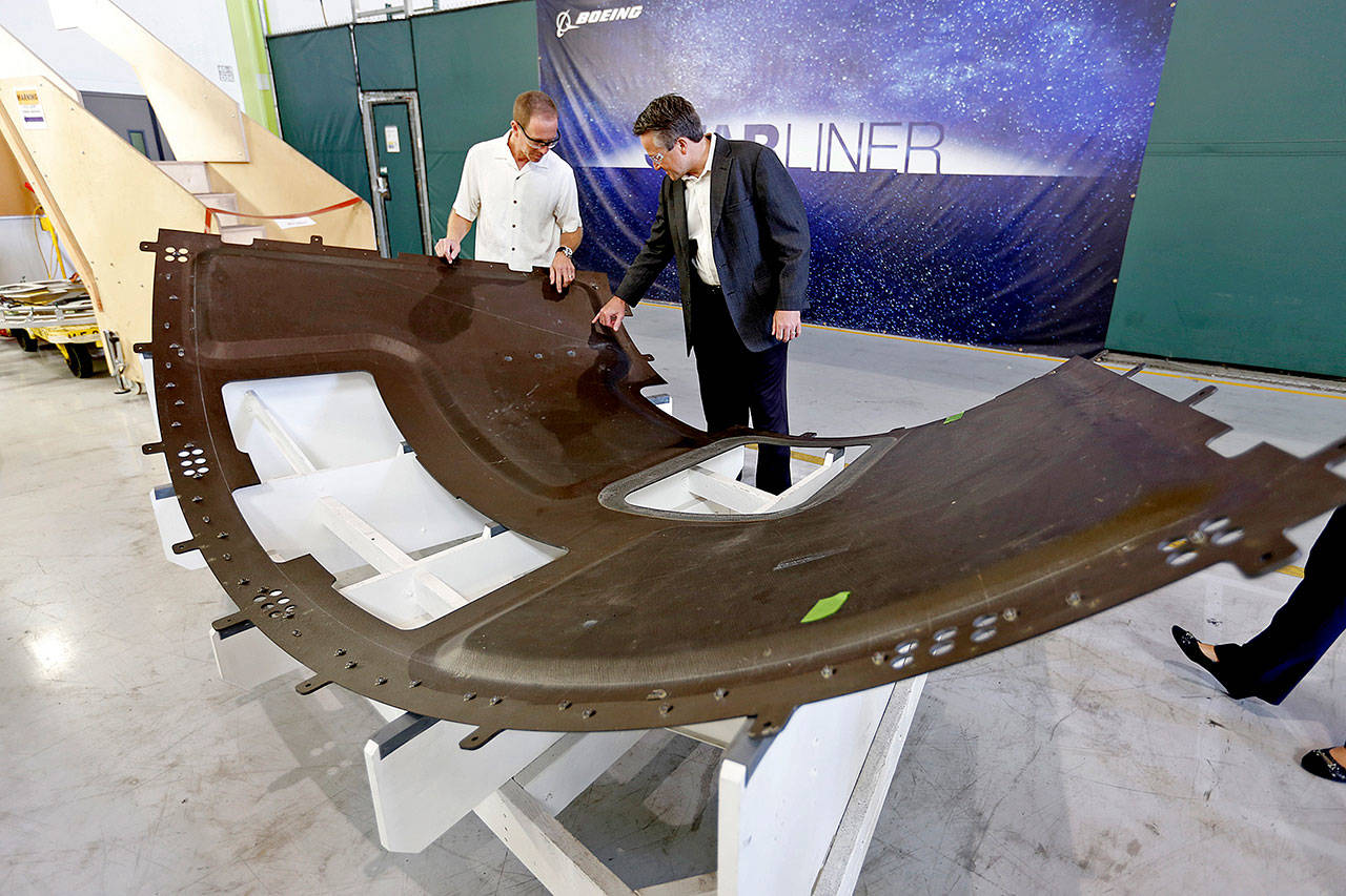 Rob Adkisson (right), chief engineer with the Commercial Group Program of the Boeing Co., and David Schiller, who works in composites and thermal production at the Boeing Huntington Beach test facility, examine a capsule heat shield component that will undergo testing to ensure the CST-100 Starliner operates as designed. Boeing is developing the Starliner capsule to transport astronauts to the International Space Station. (Al Seib / Los Angeles Times/TNS)