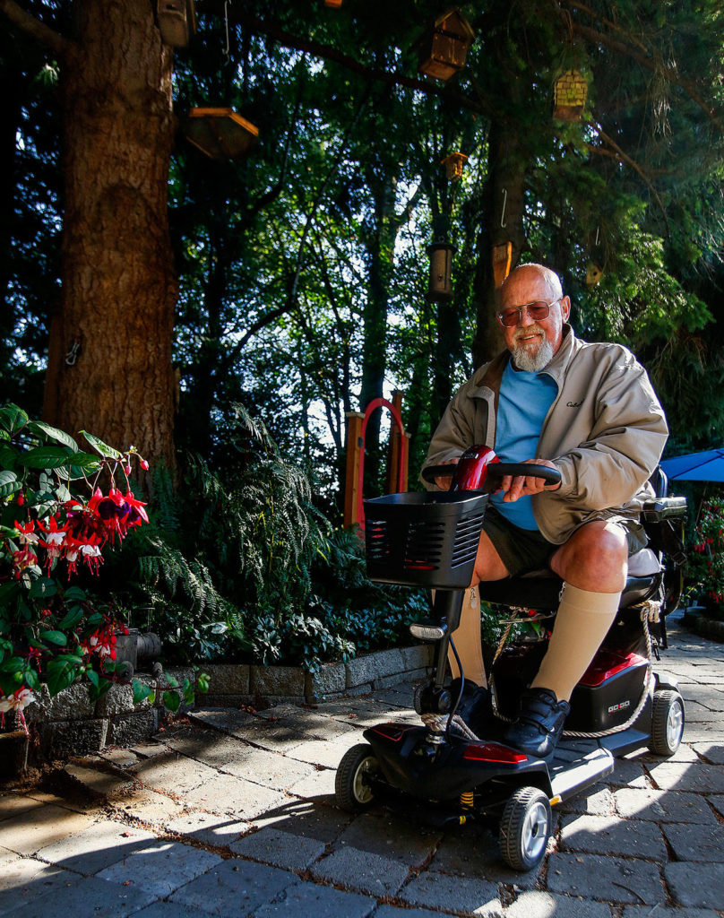 Jim Mathis was able to get around his garden paths Aug. 22 on his battery-powered transport. (Dan Bates / The Herald)
