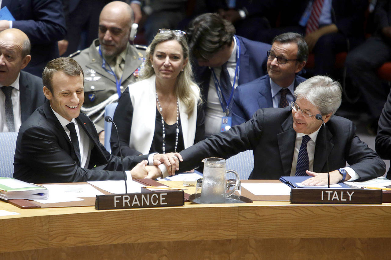French President Emmanuel Macron (left) greets Italian Prime Minister Paolo Gentiloni as he arrives for a high level meeting of the United Nations Security Council on U.N. peacekeeping operations Wednesday at U.N. headquarters. (AP Photo/Jason DeCrow)