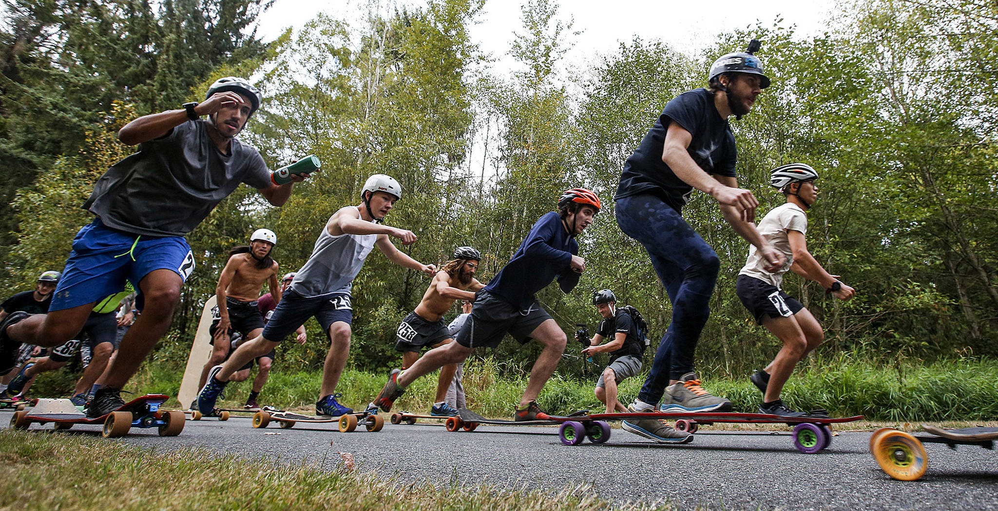 Longboarders take off from the start line at the Armar Trailhead on the Centennial Trail in Arlington for an 8.5 mile race on the trail on Saturday, Sept. 23. (Ian Terry / The Herald)