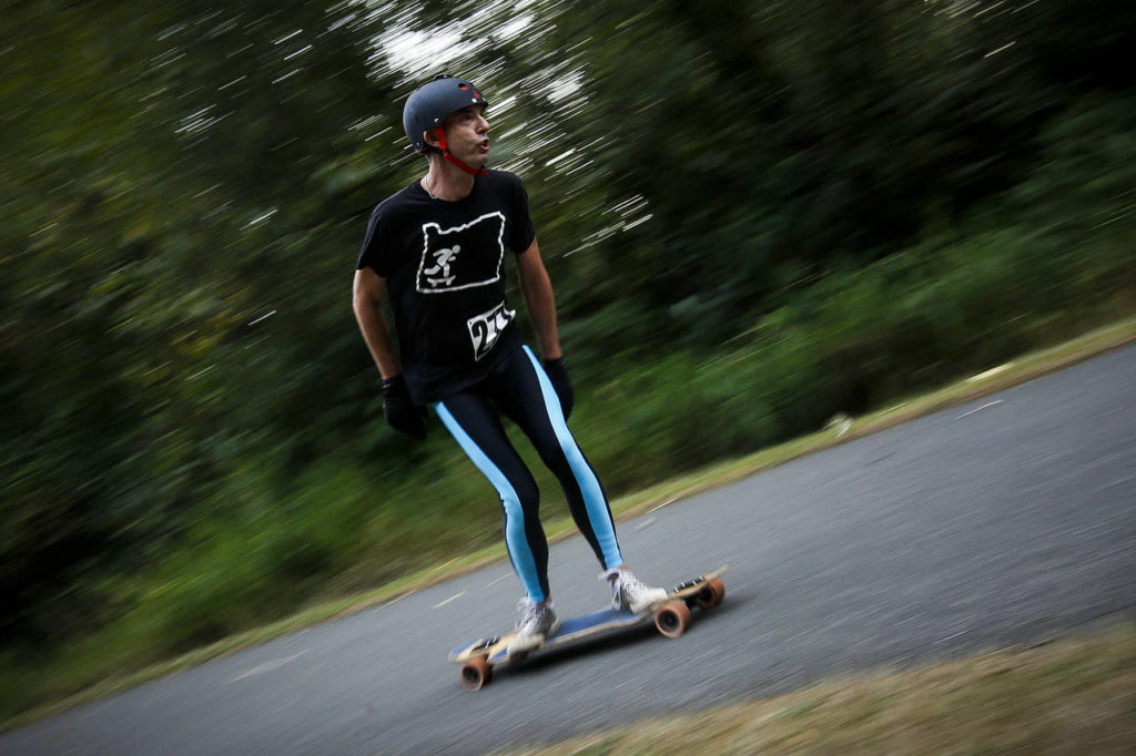 Phil Priestley, of Salem, cruises to the finish line of an 8.5 mile longboard race held on the Centennial Trail in Arlington on Saturday, Sept. 23. (Ian Terry / The Herald)
