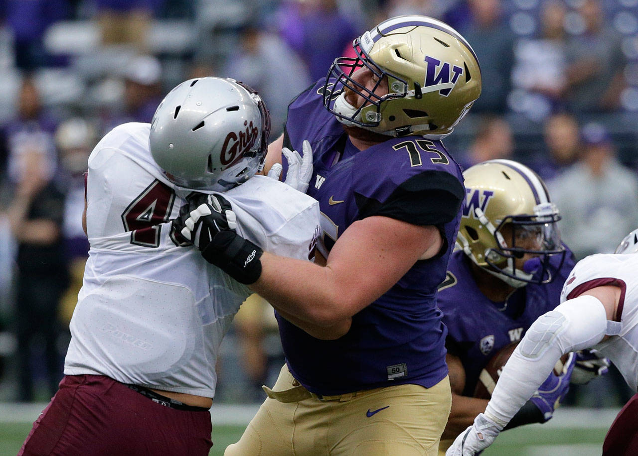 Washington offensive lineman Jesse Sosebee (75) blocks Montana defensive end Cy Sirmon in the first half of a game on Sept. 9, 2017, in Seattle. (AP Photo/Ted S. Warren)