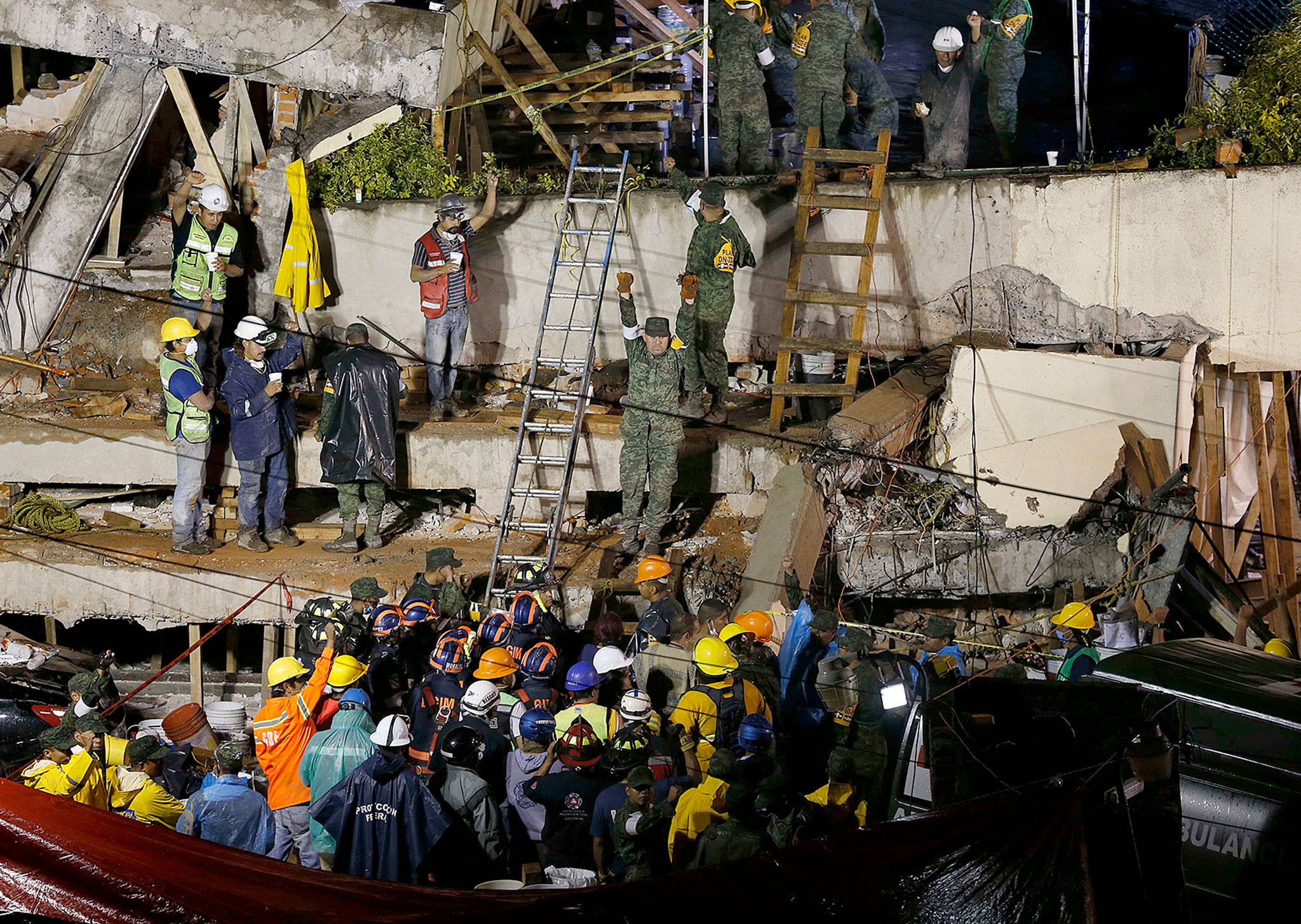 Rescue personnel work to rescue a trapped child at the collapsed Enrique Rebsamen primary school in Mexico City on Wednesday. But she never existed, Mexican officials now say. (AP Photo/Marco Ugarte)