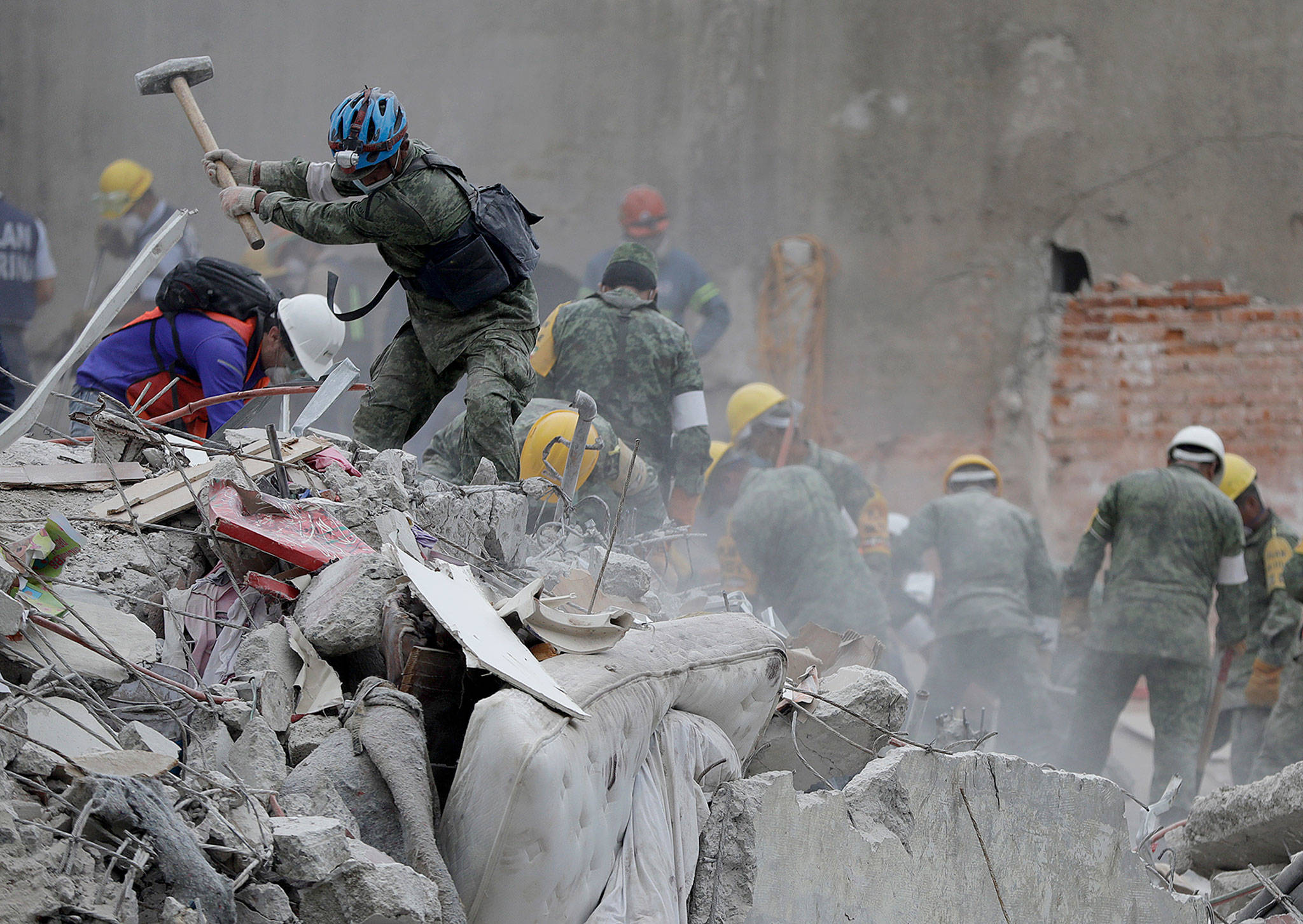 Rescue workers search for survivors at an apartment building that collapsed during an earthquake in the Condesa neighborhood of Mexico City on Thursday. (AP Photo/Natacha Pisarenko)