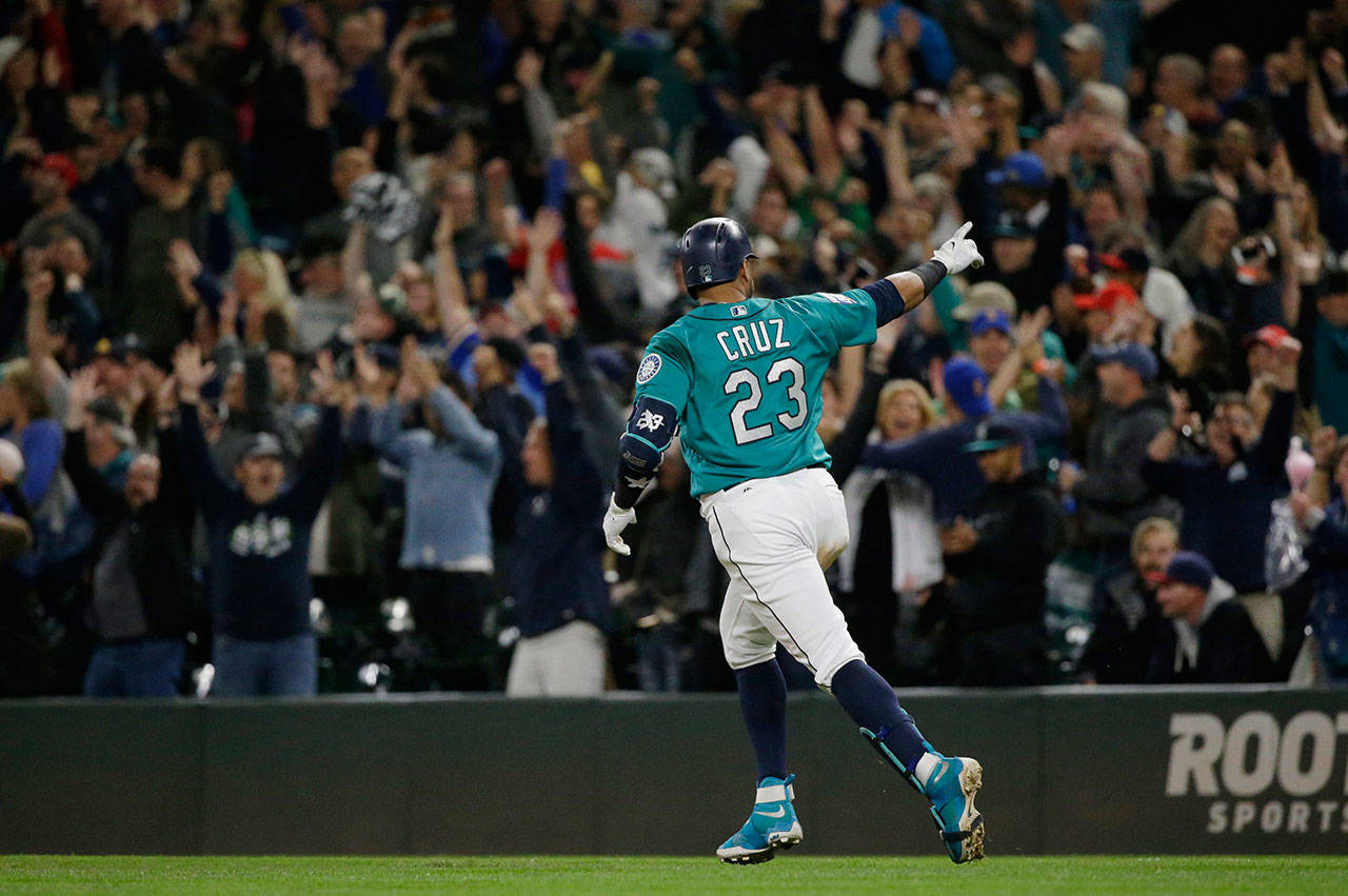 The Mariners’ Nelson Cruz points to fans as he runs the bases after hitting a walk-off home run in the ninth inning of a game against the Indians on Sept. 22, 2017, in Seattle. The Mariners won 3-1. (AP Photo/Ted S. Warren)