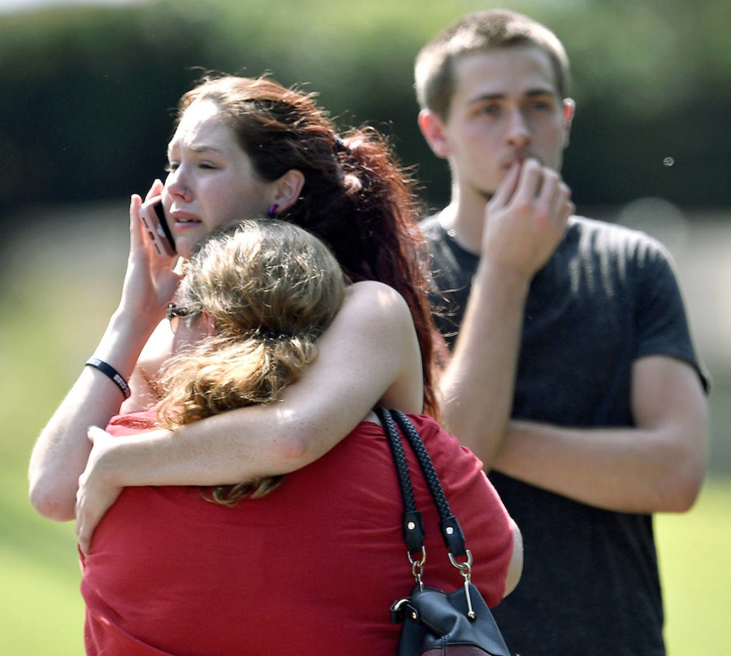 Kaitlyn Adams, a member of the Burnette Chapel Church of Christ, hugs another church member at the scene after shots were fired at the church on Sunday in Antioch, Tennessee. (Andrew Nelles/The Tennessean via AP)
