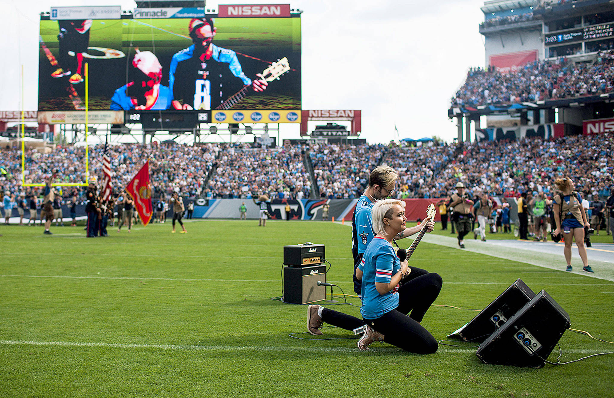Singer Meghan Lindsey takes a knee at the end of her performance of the Star Spangled Banner before the game Sunday between the Seattle Seahawks and the Tennessee Titans in Nashville. (Austin Anthony/Daily News via AP)