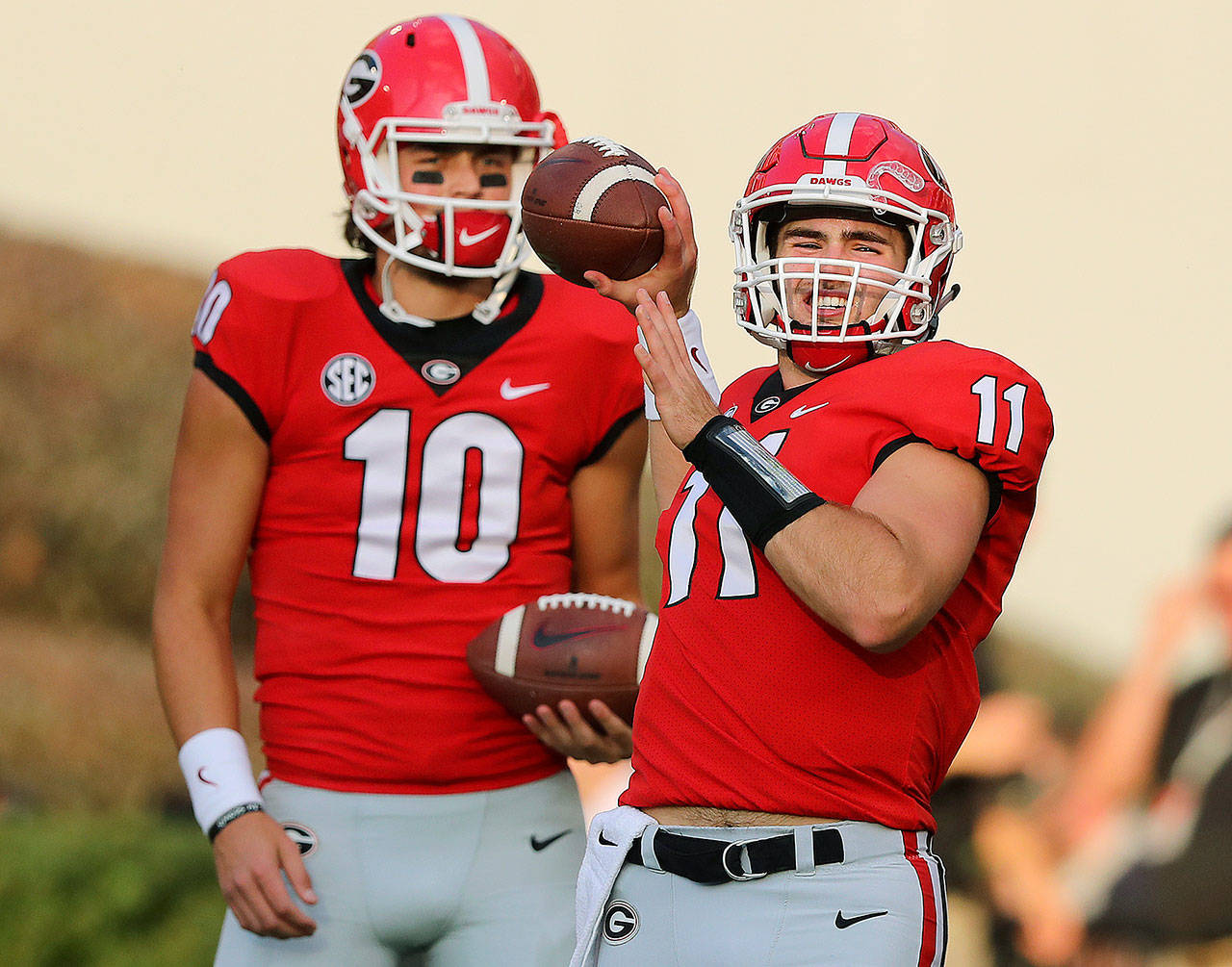 Injured Georgia quarterback Jacob Eason watches as starter Jake Fromm warms up before the team’s win over Mississippi State on Saturday in Athens, Ga. (Curtis Compton/Atlanta Journal-Constitution via AP)