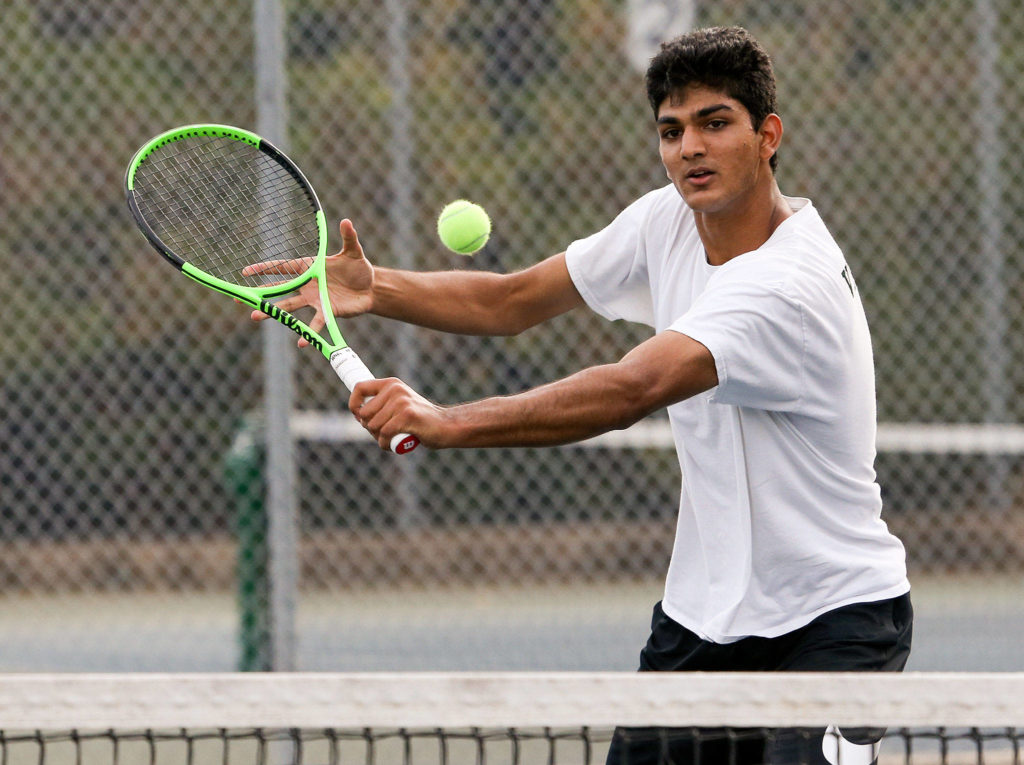 Jackson’s Anuj Vimawala returns a shot at the net to Cascade’s Yevgeniy Kolomiyets in a battle the region’s two top players on Monday in Mill Creek. Vimawala lost in straight sets. (Andy Bronson / The Herald)

