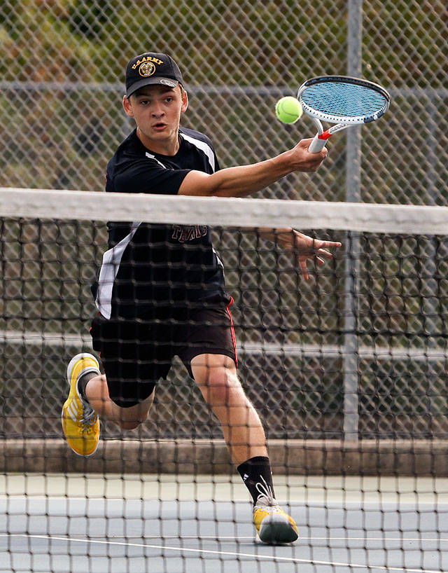 Cascade’s Yevgeniy Kolomiyets hits a shot against Jackson’s Anuj Vimawala in a showdown between two of the region’s top players on Monday in Mill Creek. Kolomiyets won in straight sets. (Andy Bronson / The Herald)