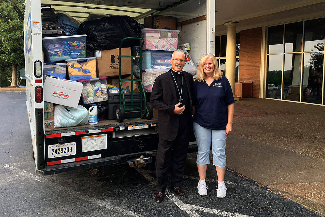 Mary Bates and North American Lutheran Church Bishop John Bradosky helped fill a truck with emergency supplies earlier this year. Bates, who’s scheduled to lead training sessions at an Everett church next week, is the denomination’s national disaster response director. (Courtesy photo)