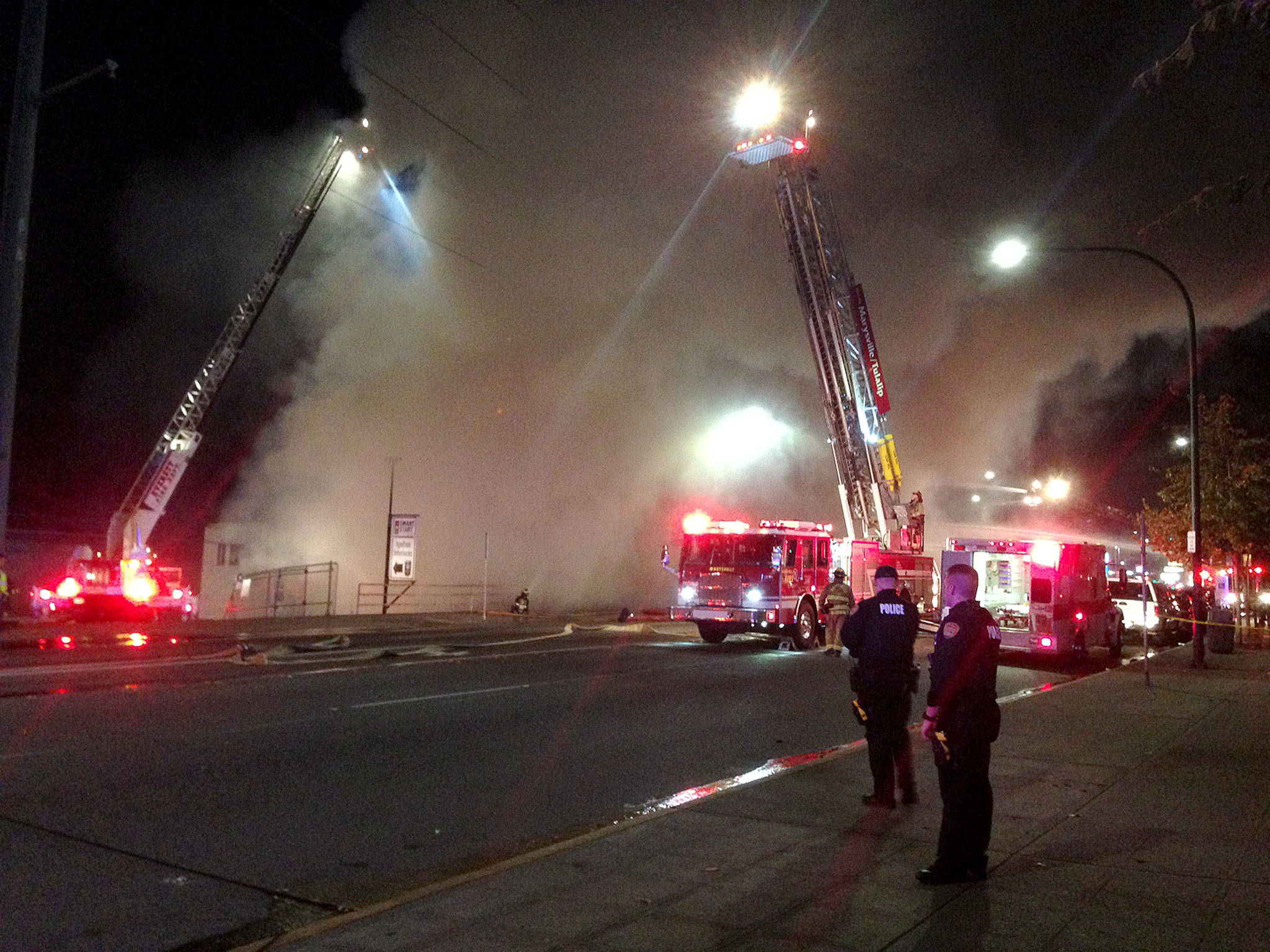 A building across Broadway from Xfinity Arena collapsed in a massive fire Monday night in downtown Everett. (Caleb Hutton / The Herald)