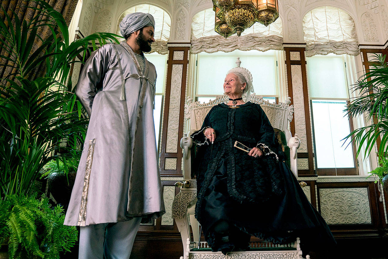 Judi Dench plays Queen Victoria and Ali Fazal portrays an ingratiating young Indian man in “Victoria and Abdul.” (Focus Features)