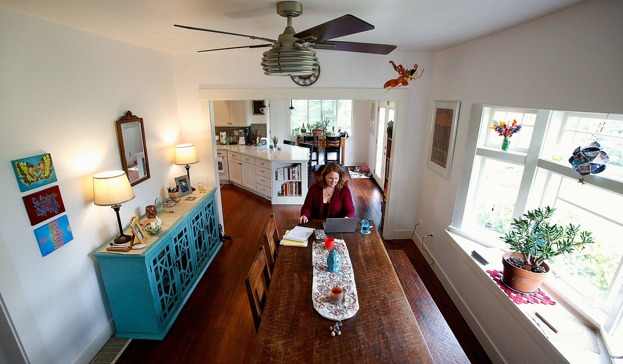 Maria Coghill and her family enjoy an open and airy layout in what formerly was a house with lots of small rooms. (Dan Bates / The Herald)