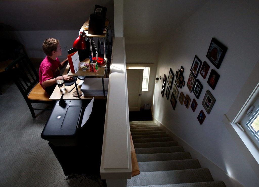 The Coghills’ 10-year-old son, Jack, works on a computer in a fully redesigned upstairs. (Dan Bates / The Herald)
