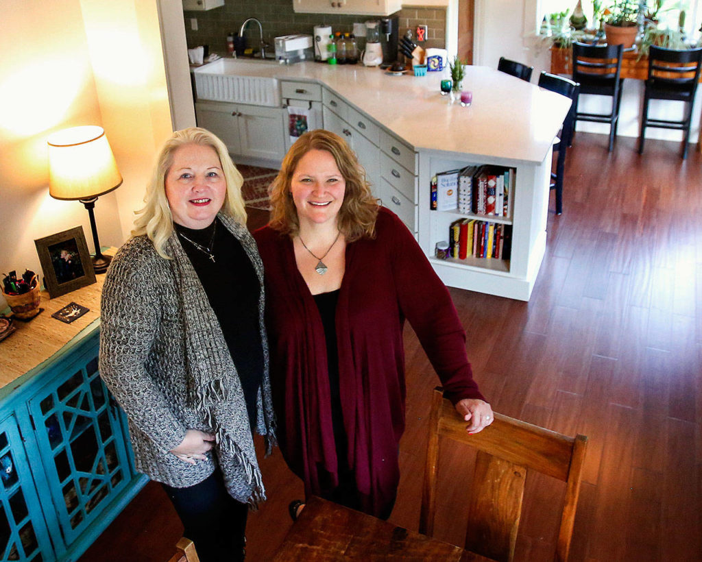 With help from SaDora Hampson (left) of Classic Remodeling NW, Maria Coghill’s small house is now lighter, airier and a better fit for the family. (Dan Bates / The Herald)
