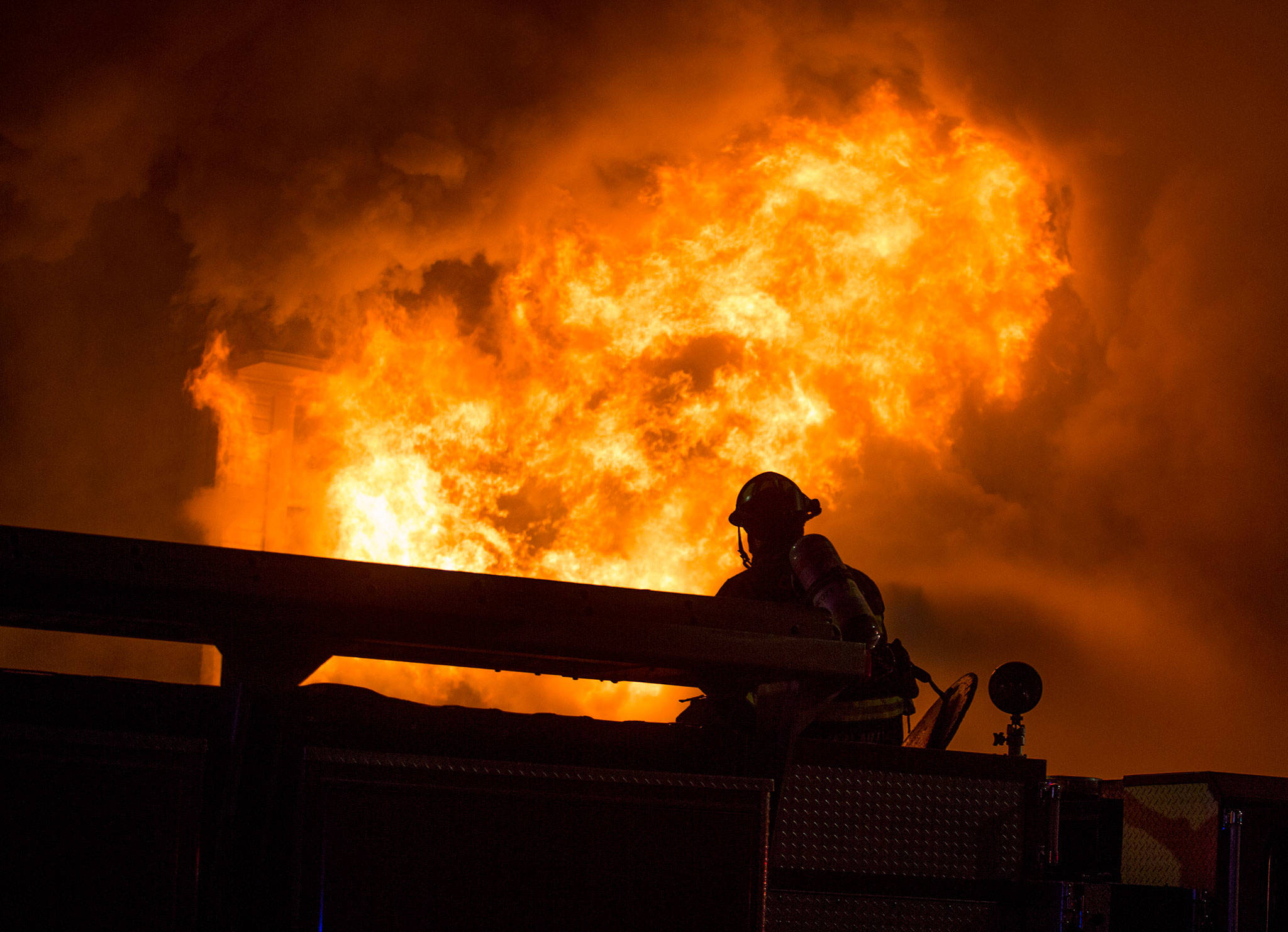 Flames burst out from the front of the Everett Office Furniture building in Everett on Monday. The fire caused damage estimated at $1.5 million. (Andy Bronson / The Herald)